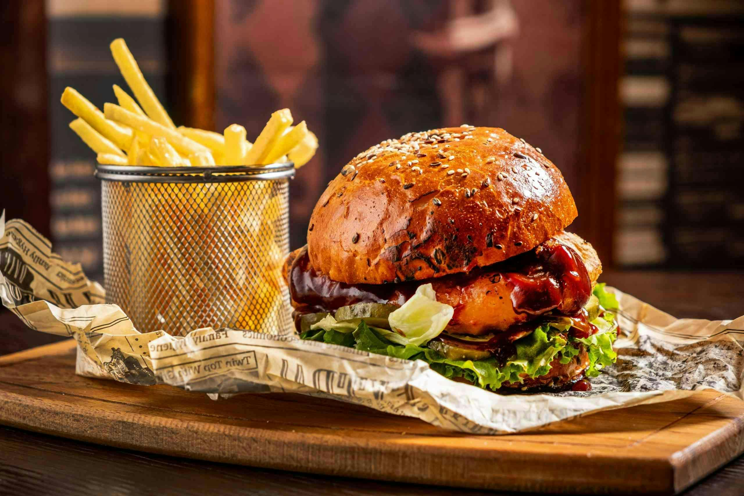 <p>tasty burger with french fries and beer</p>
