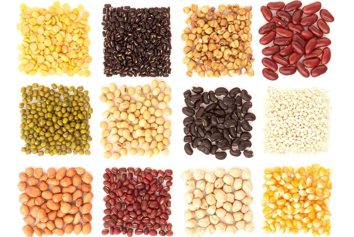 <p>Assortment of beans and lentils in wooden spoon with wood box macadamia isolated on white . mung bean groundnut soybean red kidney bean black bean red bean and brown pinto beans .</p>
